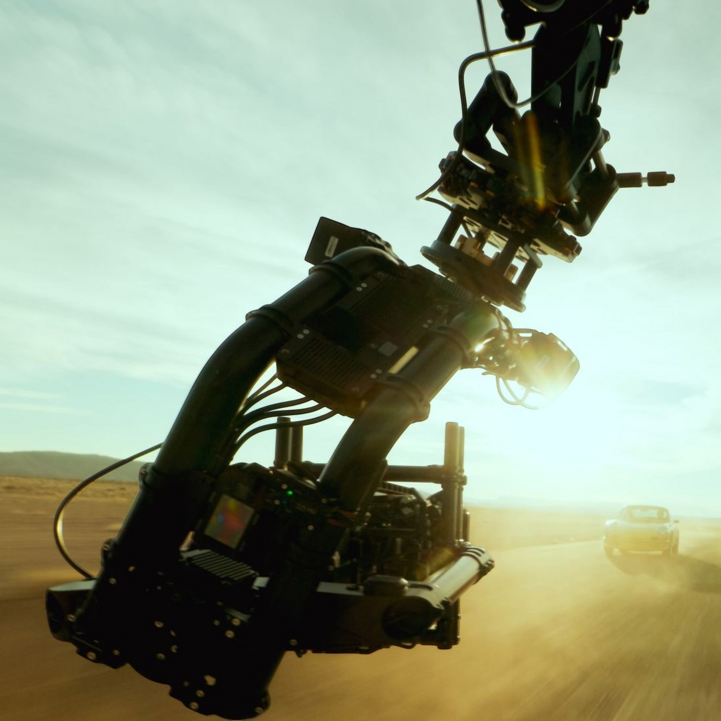 alAsil GoPro MISSION 1 PRO ILS cinema camera mounted on a high-speed vehicle rig filming a car in the desert