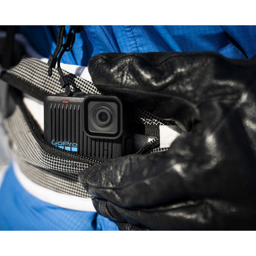 alAsil GoPro HERO action camera tucked into a waist pack, worn by a person in a blue jacket and black gloves.