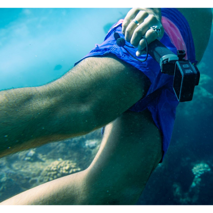 alAsil GoPro HERO12 Black action camera held underwater by a swimmer, capturing footage of a coral reef.