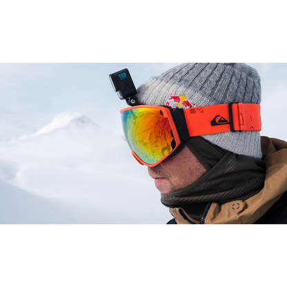 alAsil GoPro HERO13 Black action camera mounted on a skier wearing orange goggles and a grey beanie in snowy mountains