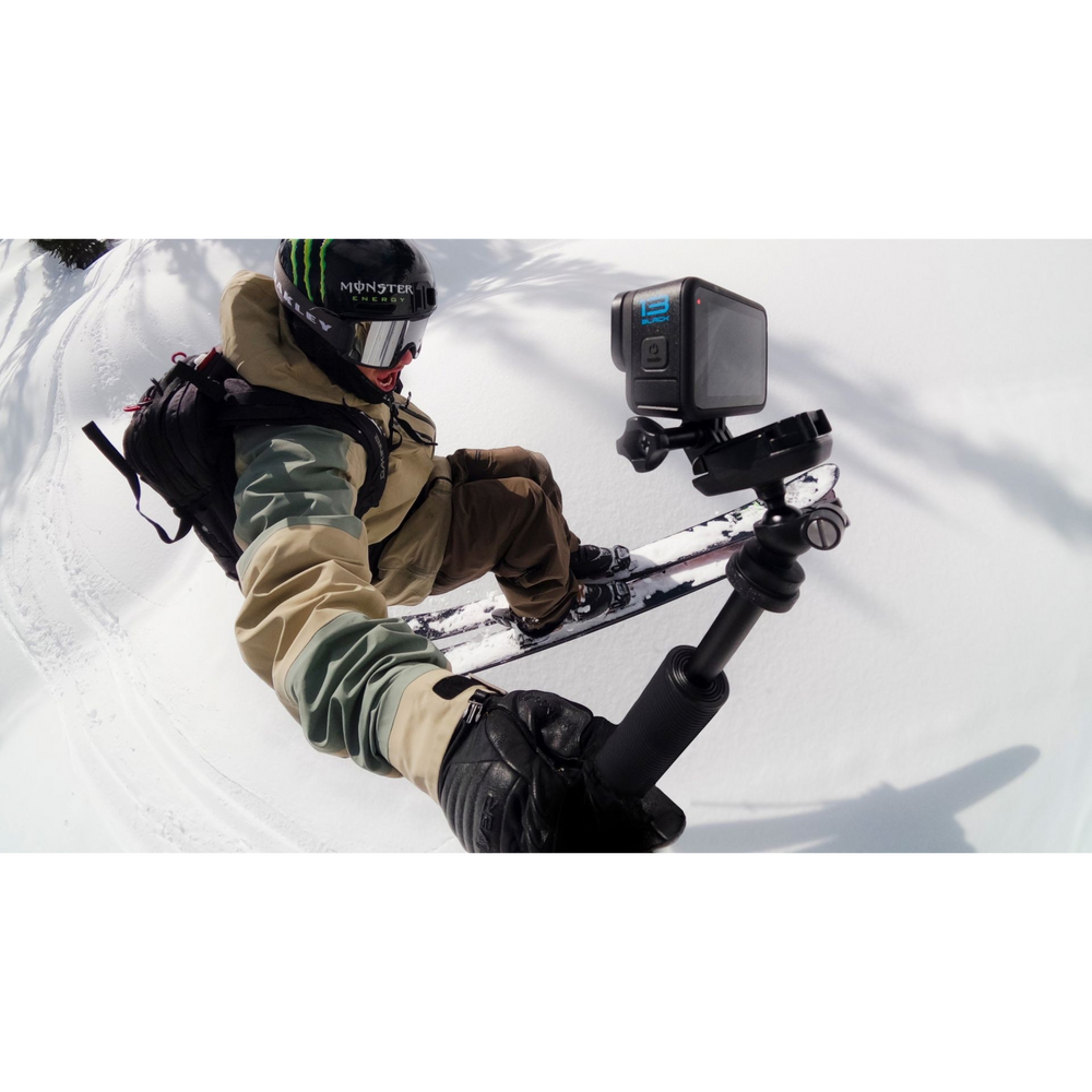 alAsil GoPro HERO13 Black action camera mounted on a selfie stick held by a skier on a snowy mountain slope