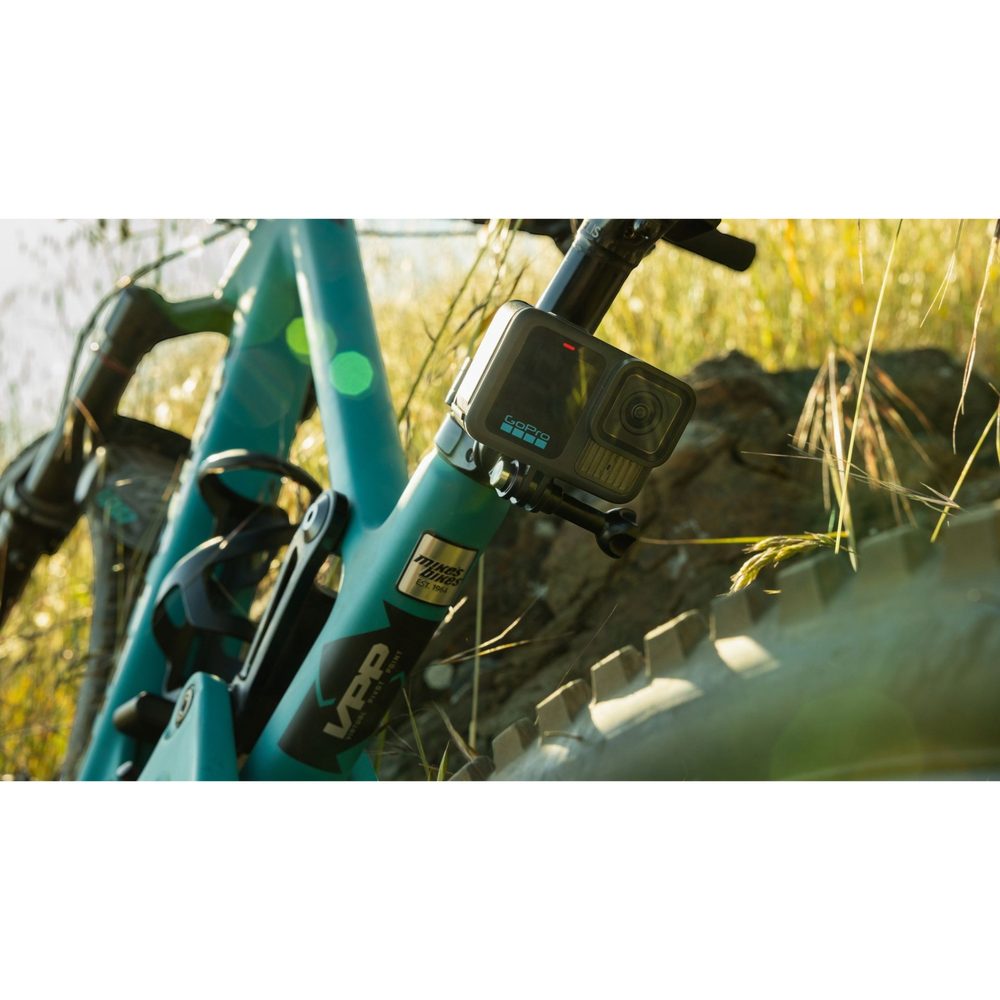 alAsil GoPro HERO13 Black action camera mounted on a teal mountain bike frame outdoors in sunlight