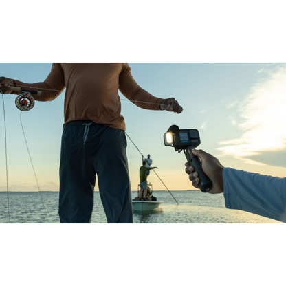 alAsil GoPro HERO13 Black Creator Edition camera held on a battery grip filming a person fly fishing on a boat