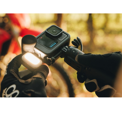 alAsil GoPro HERO13 Black Creator Edition action camera with LED light and microphone grip held by gloved hands