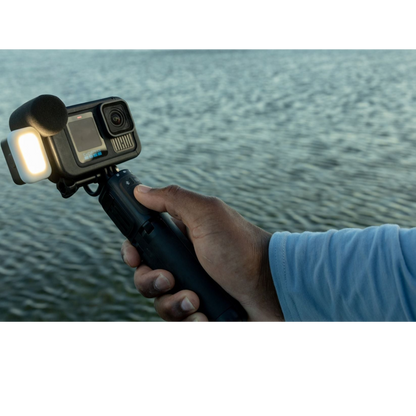 alAsil GoPro HERO13 Black Creator Edition action camera with LED light and microphone grip held over water