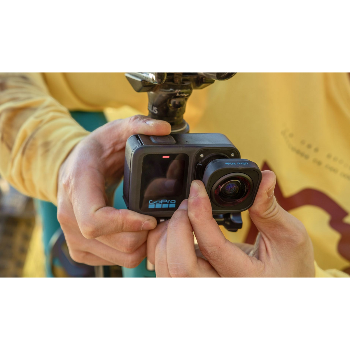 alAsil GoPro HERO13 Black action camera with Ultra Wide Lens Mod being attached by hands for immersive POV shots