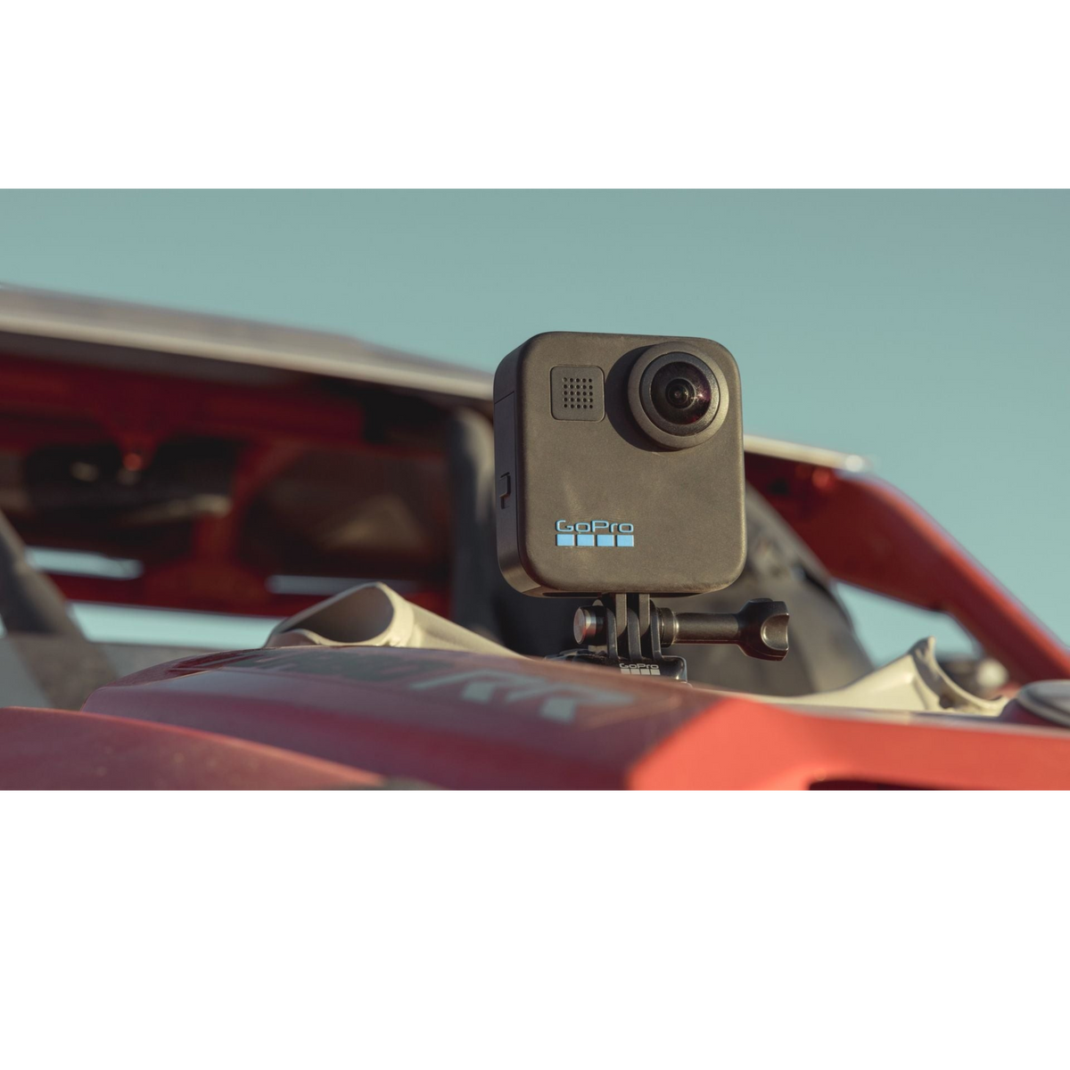 alAsil GoPro MAX 360 action camera mounted on a red vehicle, featuring dual lenses for immersive 360-degree video.