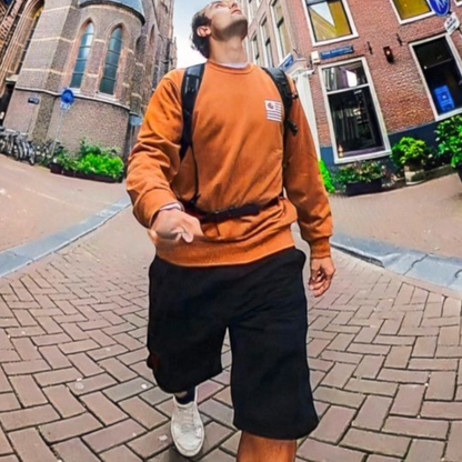 alAsil GoPro MAX 360 camera wide-angle shot of a man walking on a brick street in a city