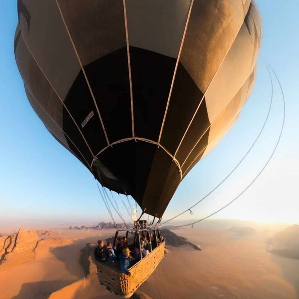 alAsil GoPro MAX 360 camera capturing a wide-angle view of a hot air balloon flight over a desert landscape