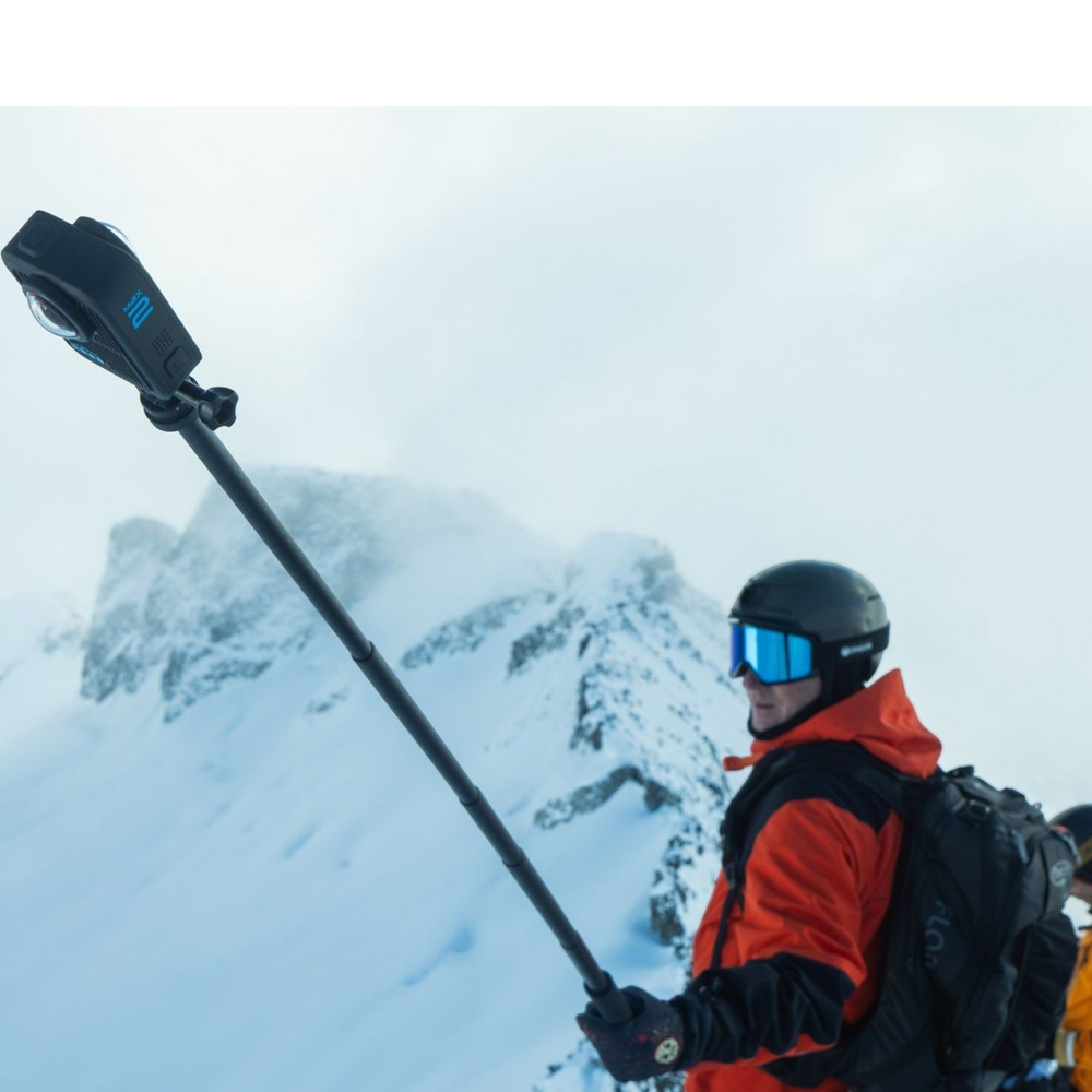 alAsil GoPro MAX2 360 camera mounted on an extension pole held by a skier on a snowy mountain peak