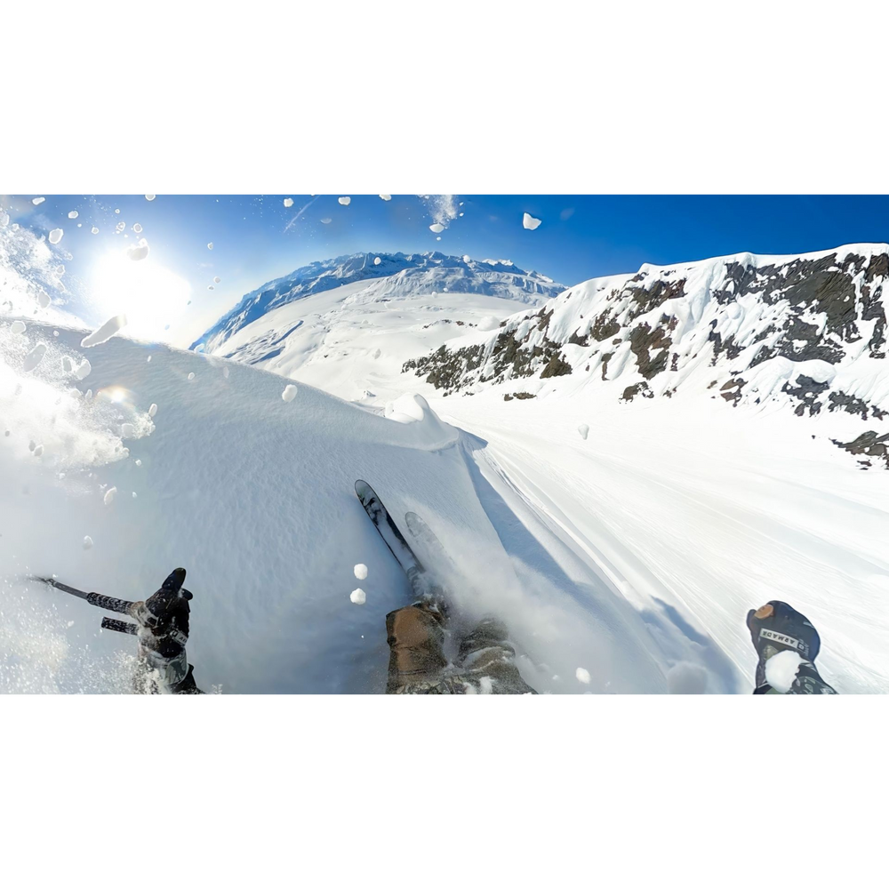 alAsil GoPro MAX2 360 camera POV shot of a skier carving through deep powder on a sunny mountain slope