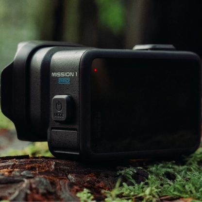 alAsil GoPro MISSION 1 PRO cinema camera in a rugged black waterproof body resting on a mossy forest log