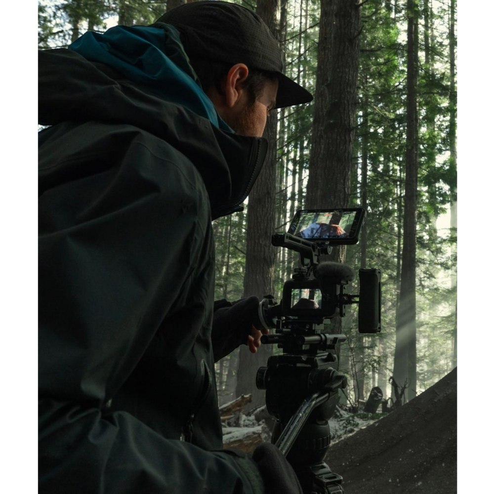 alAsil GoPro MISSION 1 PRO ILS cinema camera mounted on a tripod, used by a filmmaker in a misty forest setting.