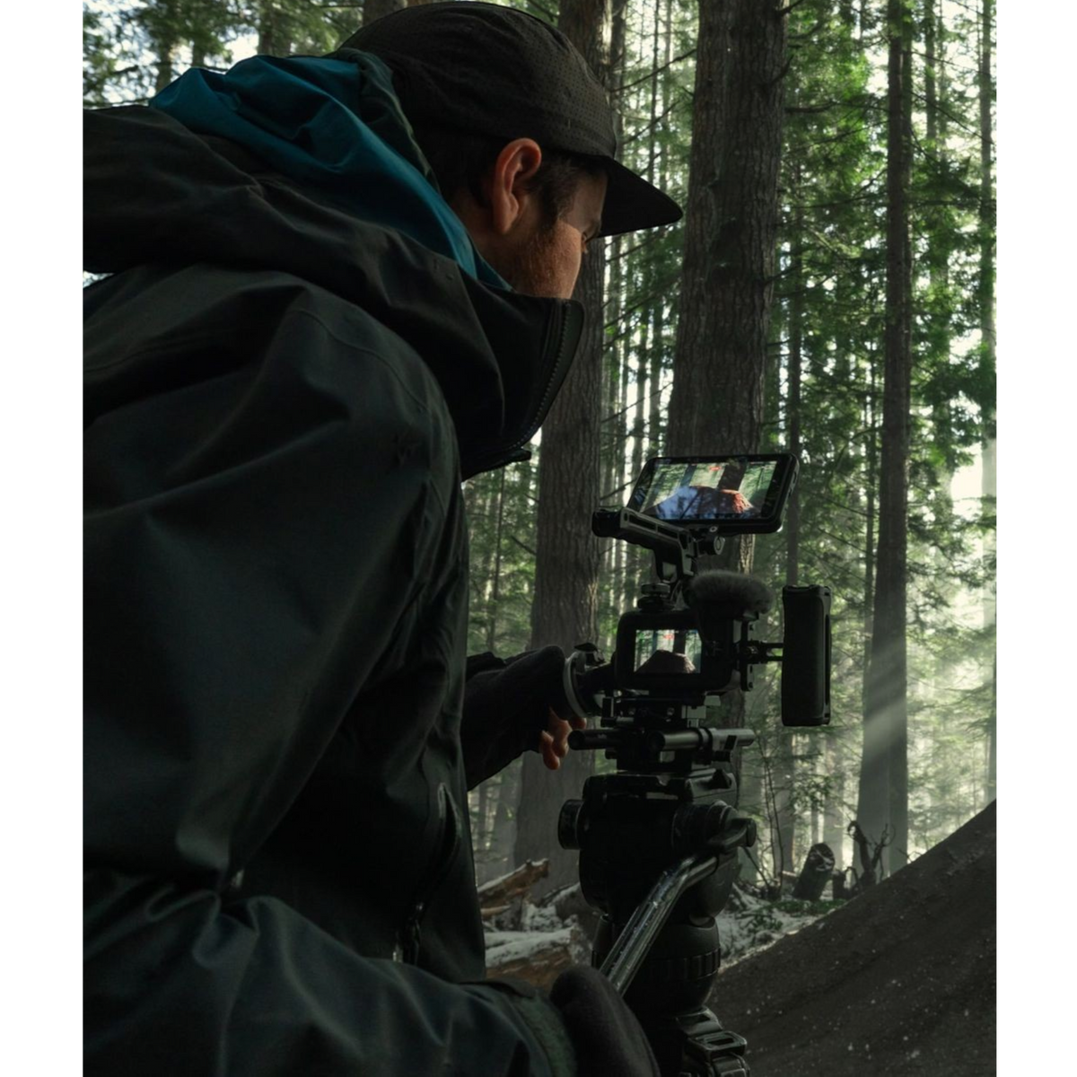 alAsil GoPro MISSION 1 PRO ILS cinema camera mounted on a tripod, used by a filmmaker in a misty forest setting.