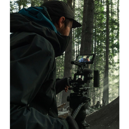 alAsil GoPro MISSION 1 PRO ILS cinema camera mounted on a tripod, used by a filmmaker in a misty forest setting.