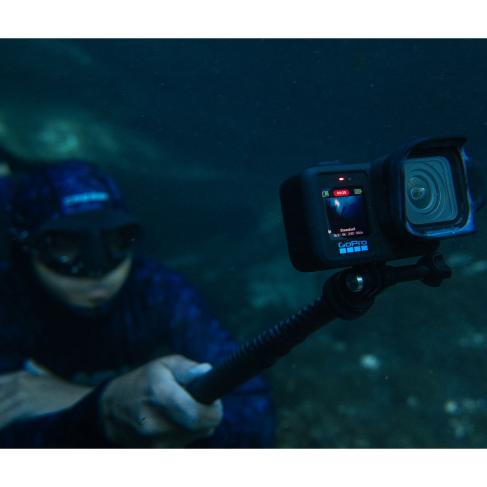 alAsil GoPro MISSION 1 PRO cinema camera mounted on a pole, capturing underwater footage with a diver in the background