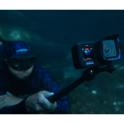 alAsil GoPro MISSION 1 PRO cinema camera mounted on a pole, capturing underwater footage with a diver in the background