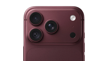 Close-up of the back of a smartphone in a deep burgundy or plum metallic finish, showing three rear cameras, a flash, and a small circular cutout on a plain white background.
