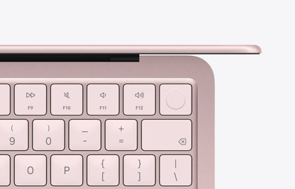 Top view of a MacBook Neo in blush color, showcasing the keyboard and function keys.