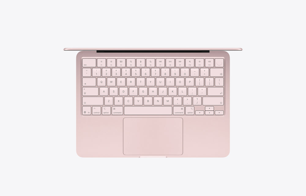 Top view of a MacBook Neo in blush color featuring a 512GB storage keyboard and touchpad.