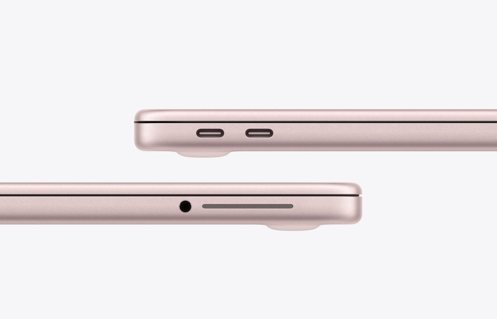Side view of a blush-colored MacBook Neo showcasing USB-C ports and headphone jack.