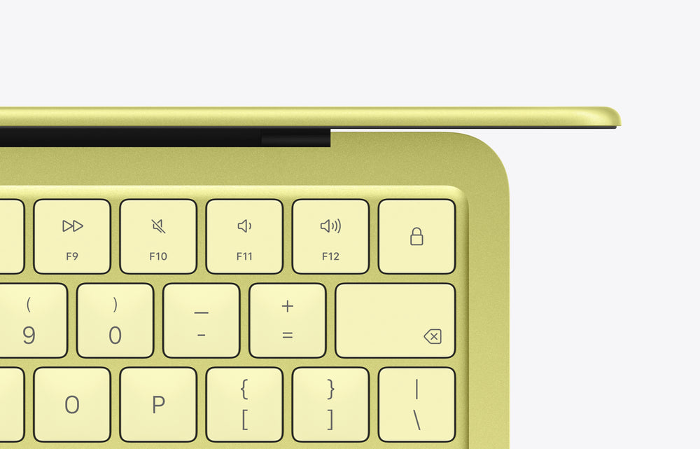 MacBook Neo in citrus color featuring a yellow keyboard with function and numerical keys visible.