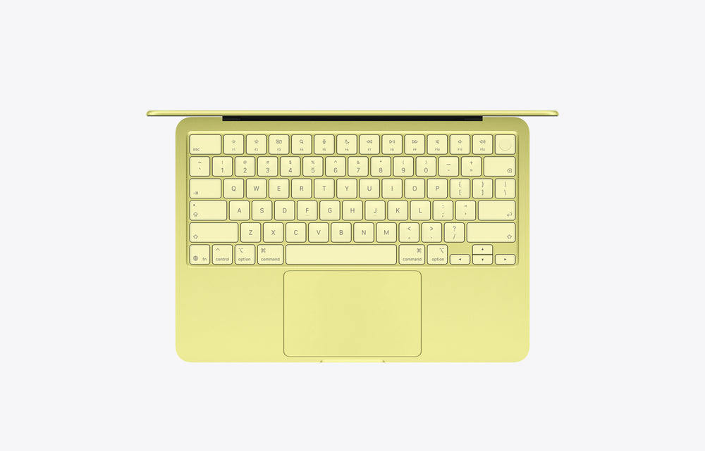 Top view of a yellow MacBook Neo Citrus with a 512GB SSD, showcasing the keyboard and trackpad.
