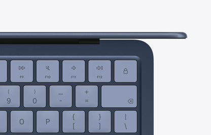 Close-up view of the indigo keyboard on a MacBook Neo with visible function keys and a sleek design.