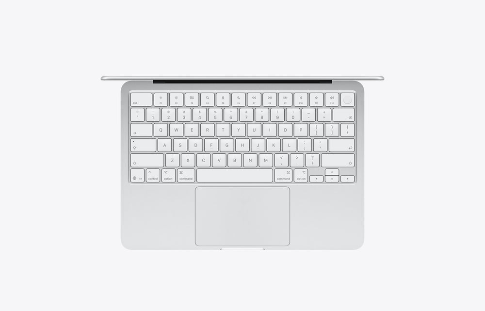 Top view of a silver MacBook with a 512GB storage capacity, showcasing its keyboard and trackpad.