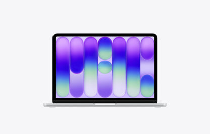 MacBook Neo in silver, displaying a vibrant purple and green abstract wallpaper on its screen.